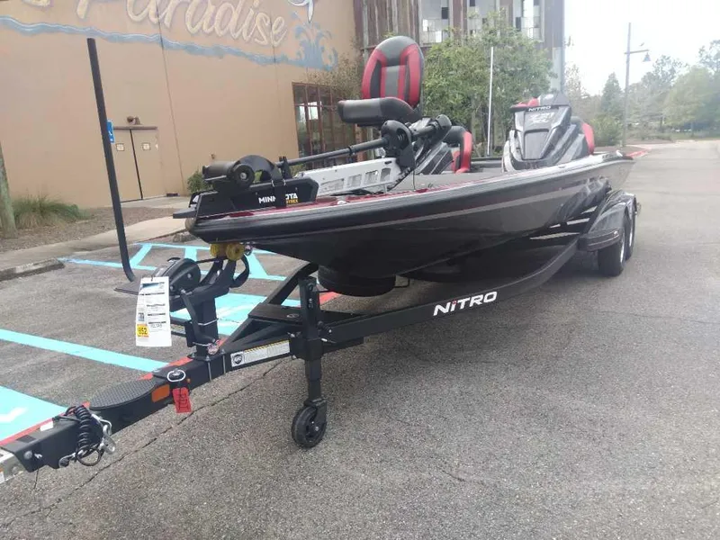 Slide: The Image of 2025 Nitro Z21 XL boat on trailer, parked in urban setting. - 16