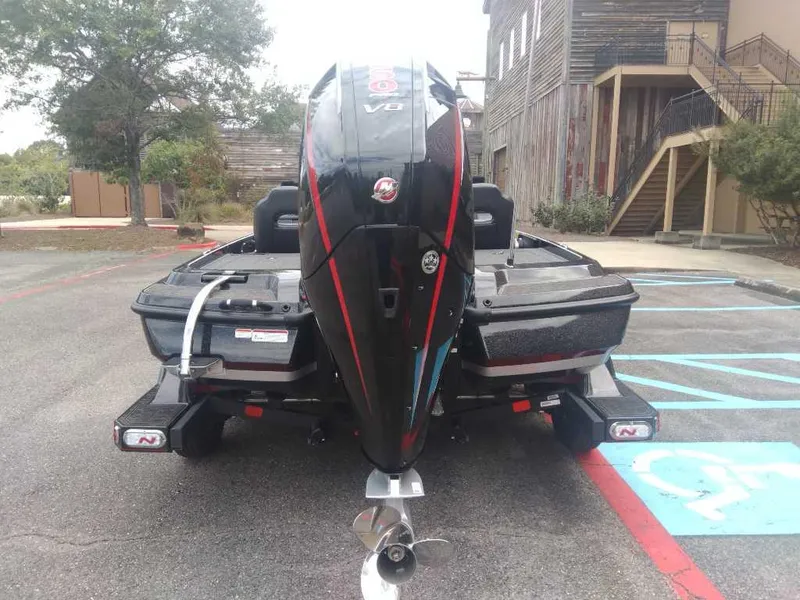 Slide: The Image of 2025 Nitro Z21 XL boat with powerful V6 engine in parking lot. - 2