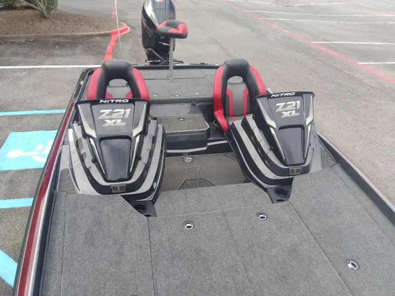 Slide: The Image of 2025 Nitro Z21 XL boat with dual seats in a parking lot. - 9