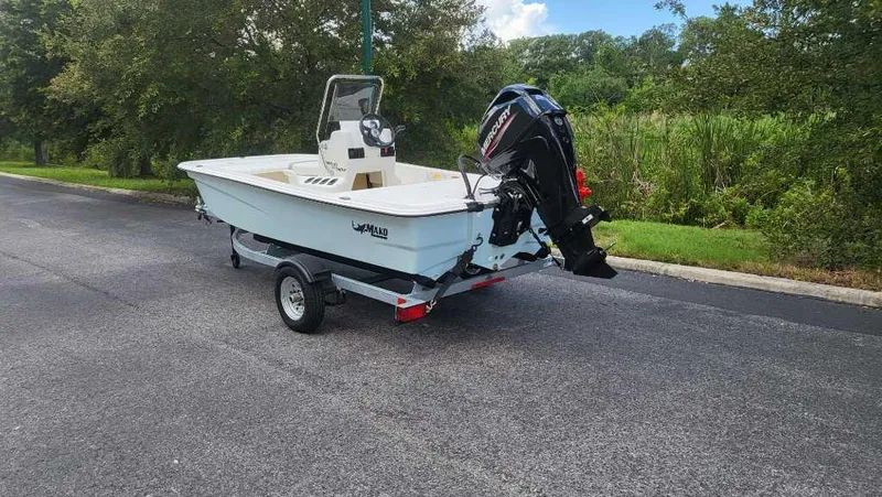 Slide: The Image of 2025 Mako Pro Skiff 13 CC boat on trailer, parked on road. - 4