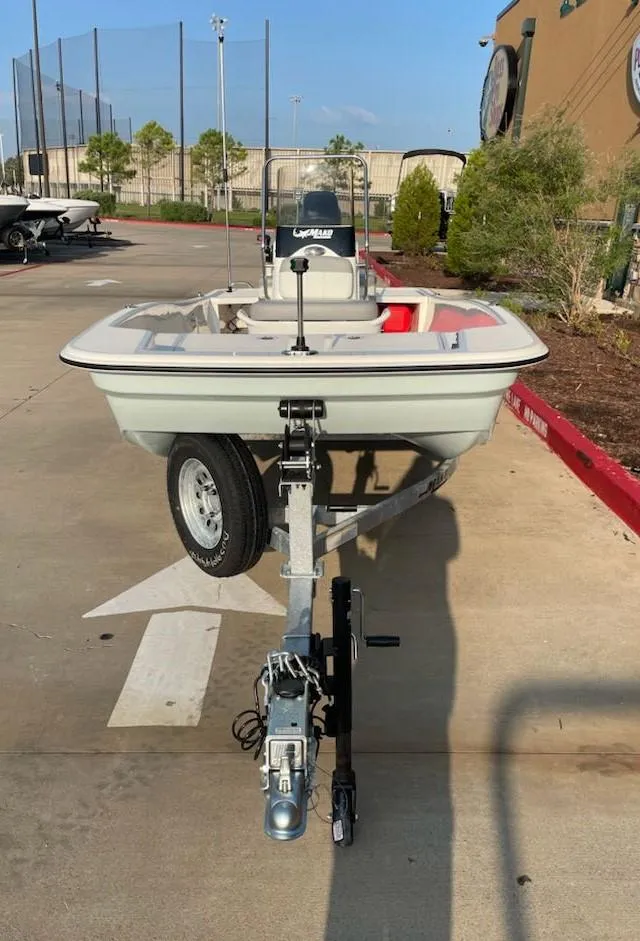 Slide: The Image of 2025 Mako Pro Skiff 15 CC boat on trailer in outdoor setting. - 2