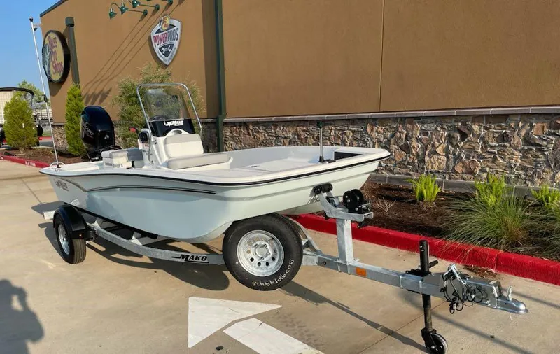 Slide: The Image of 2025 Mako Pro Skiff 15 CC boat on trailer, parked outdoors. - 3