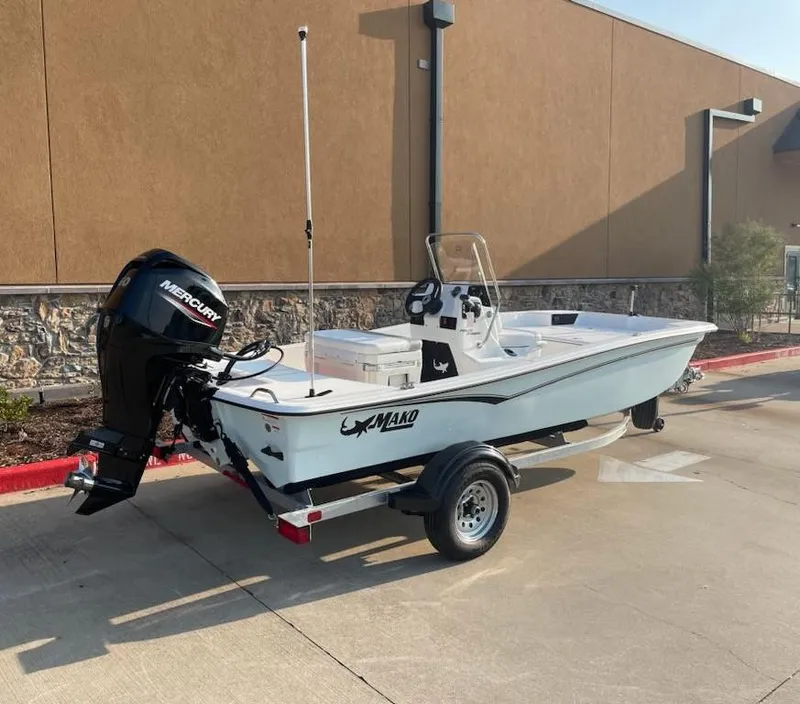 Slide: The Image of 2025 Mako Pro Skiff 15 CC boat on trailer, parked outdoors. - 5