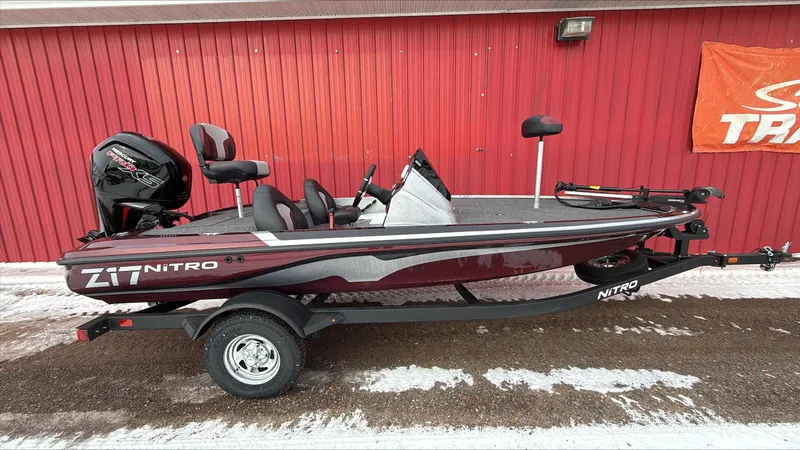 The Image of 2025 Nitro Z17 boat with trailer, parked by a red wall, featuring sleek design and modern equipment. - 0