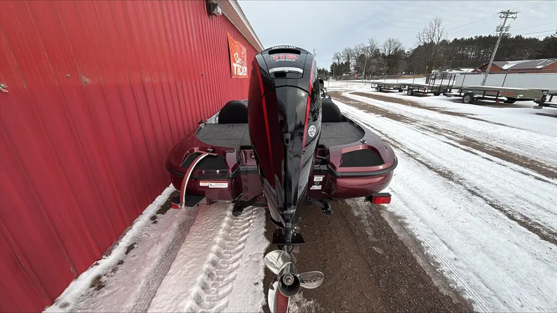 Slide: The Image of 2025 Nitro Z17 boat parked on snowy ground beside a red building. - 4
