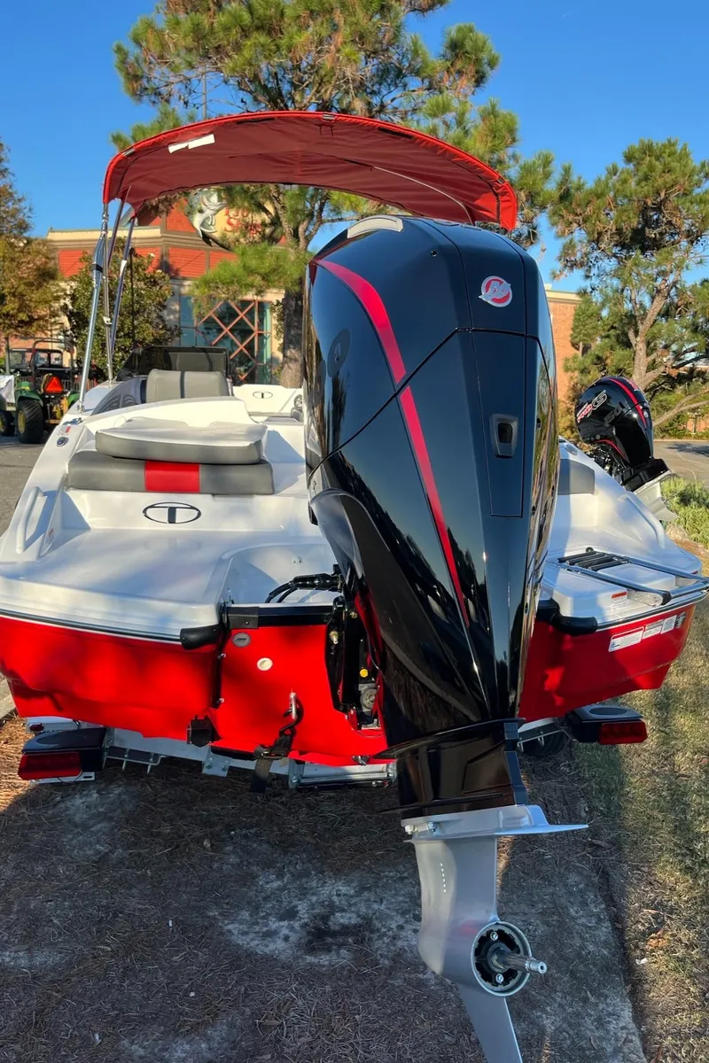 Slide: The Image of 2025 Tahoe T21 boat with red and white design, featuring a powerful outboard motor. - 4