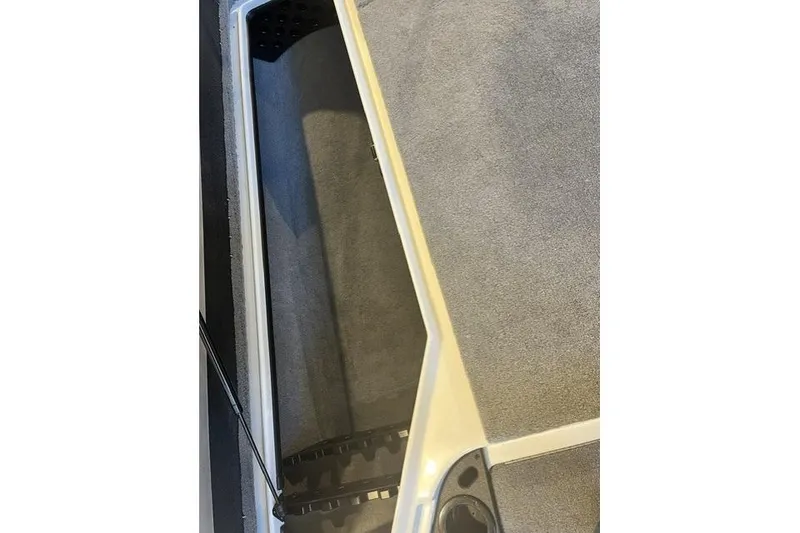 Slide: The Image of Interior view of a 2025 Nitro Z20 XL boat, showcasing carpeted flooring and storage compartment. - 123