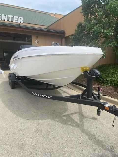 Slide: The Image of 2025 Tahoe T21 boat on trailer outside a building. - 1