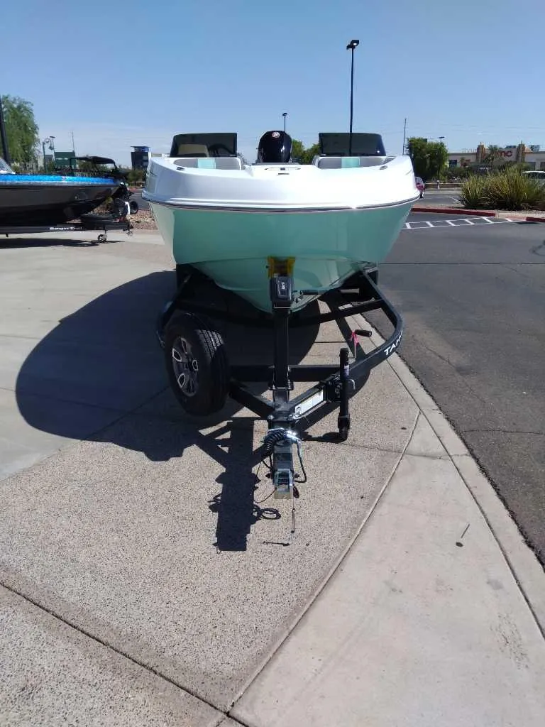 Slide: The Image of 2025 Tahoe T21 boat on trailer in parking lot. - 3