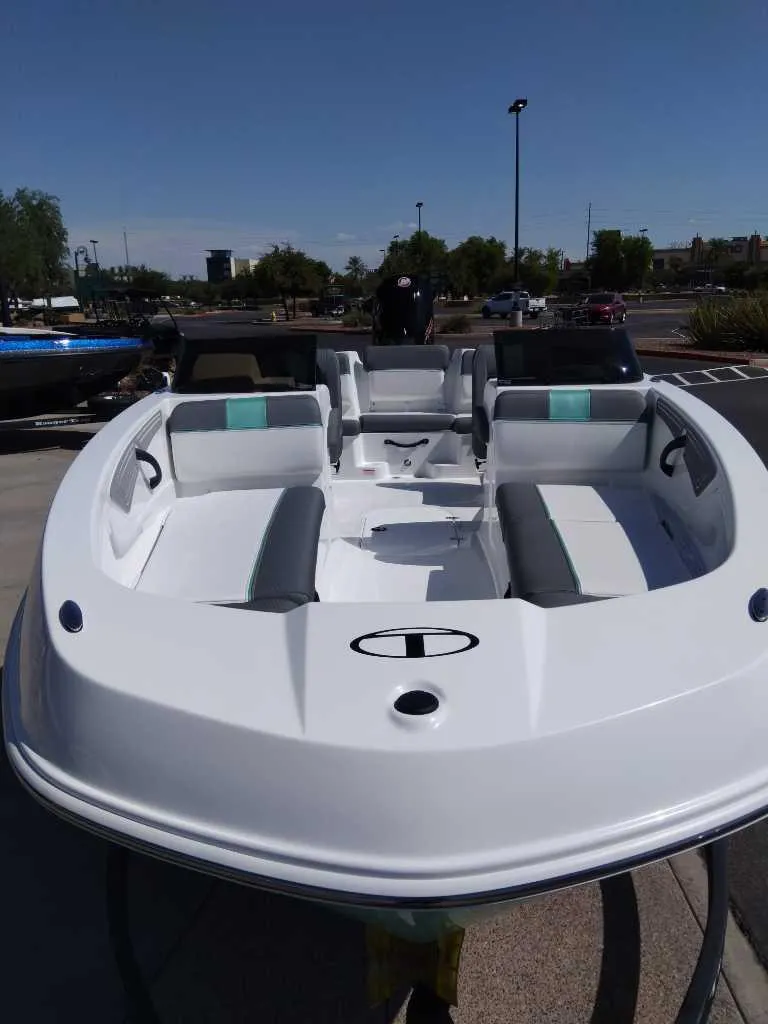 Slide: The Image of 2025 Tahoe T21 boat with sleek white design and spacious seating. - 4