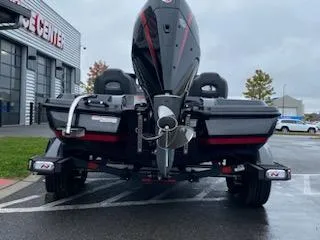 Slide: The Image of 2025 Nitro Z21 XL Pro boat, rear view, parked outdoors on a rainy day. - 11