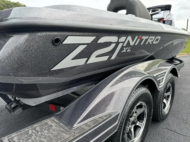 Slide: The Image of 2025 Nitro Z21 XL boat on trailer, showcasing sleek design and branding. - 3