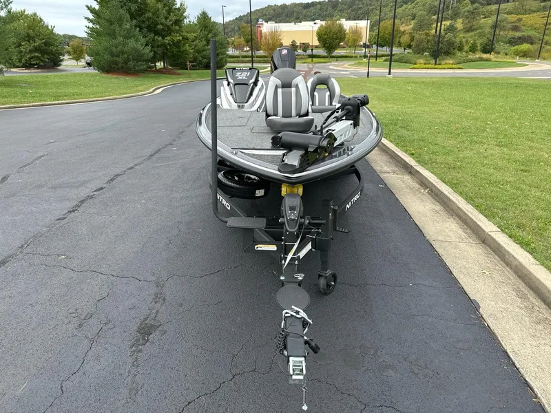 Slide: The Image of 2025 Nitro Z21 XL boat on a trailer in a parking lot. - 5