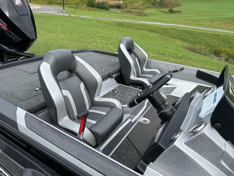 Slide: The Image of 2025 Nitro Z21 XL boat interior with dual gray seats and steering wheel. - 6