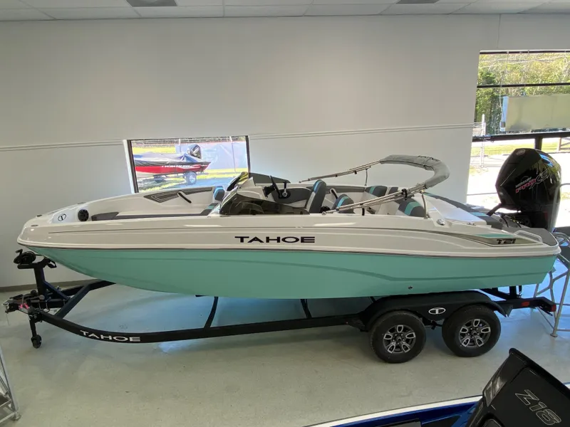 The Image of 2025 Tahoe T21 boat on trailer in showroom, side view. - 0