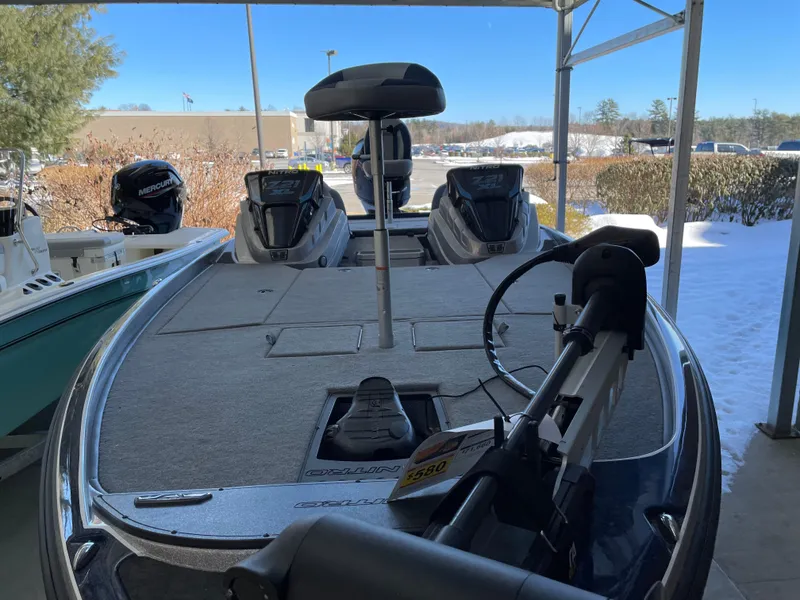 Slide: The Image of 2025 Nitro Z21 XL boat with dual engines, parked under a canopy in a snowy setting. - 4