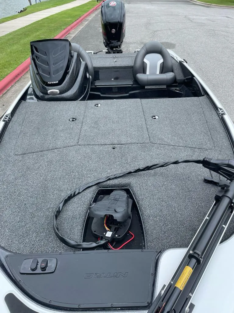 Slide: The Image of 2025 Nitro Z17 boat interior with seating and motor, parked by a lakeside. - 3