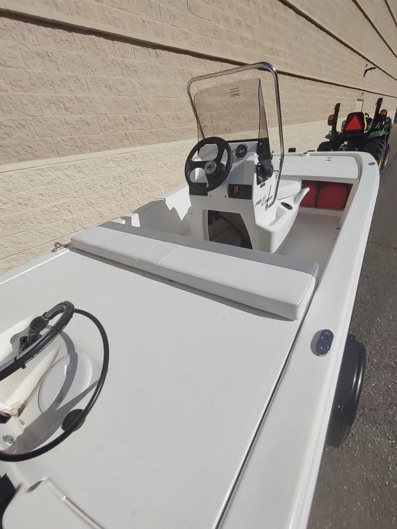 Slide: The Image of 2025 Mako Pro Skiff 13 CC boat with steering console and seating. - 3