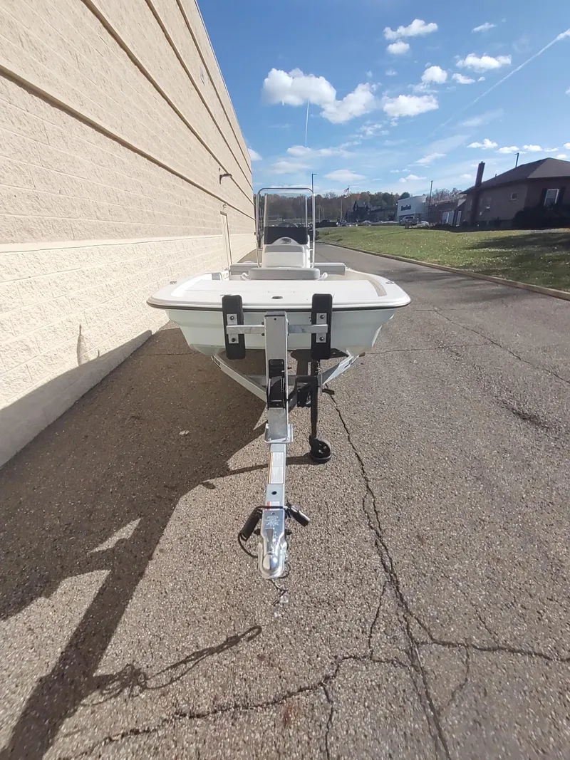 Slide: The Image of 2025 Mako Pro Skiff 13 CC boat on trailer, parked outdoors. - 5