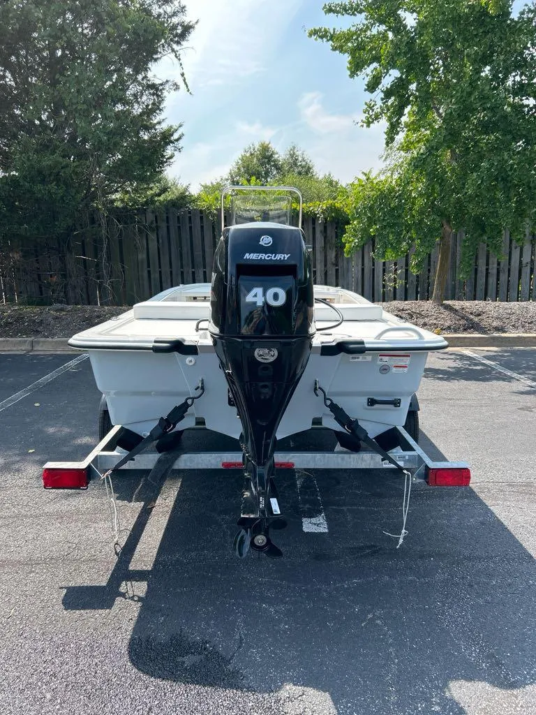 Slide: The Image of 2025 Mako Pro Skiff 13 CC with Mercury 40 engine on trailer, parked outdoors. - 3
