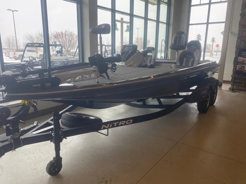 The Image of 2025 Nitro Z20 XL Pro boat displayed indoors with trailer. - 0