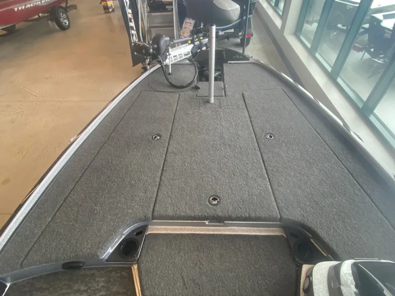 Slide: The Image of 2025 Nitro Z20 XL Pro boat deck with carpeted surface and fishing equipment. - 6