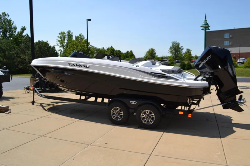 The Image of 2025 Tahoe T21 boat on trailer, parked outdoors on sunny day. - 0