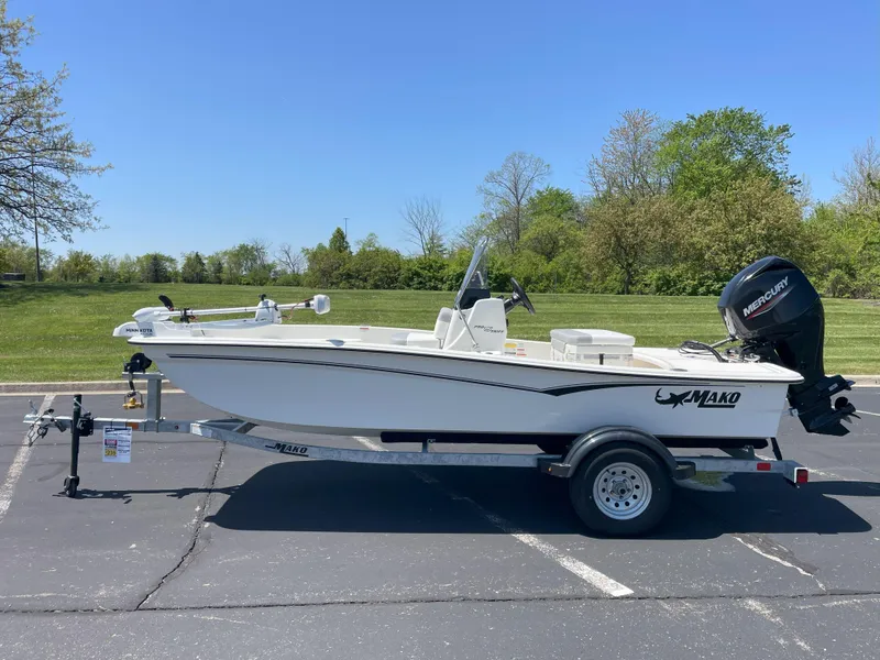 The Image of 2025 Mako Pro Skiff 15 CC boat on trailer, parked in sunny outdoor setting. - 0