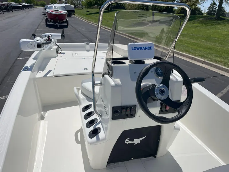 Slide: The Image of 2025 Mako Pro Skiff 15 CC boat interior with steering wheel and Lowrance equipment. - 4