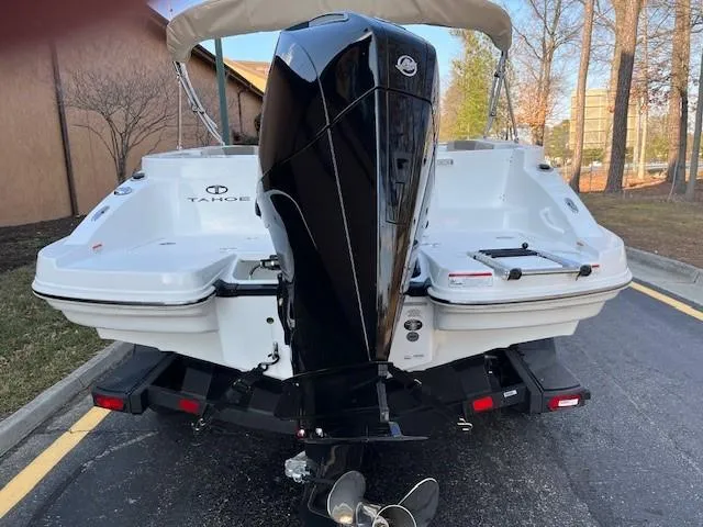 Slide: The Image of 2025 Tahoe 2150 CC boat with powerful outboard motor, parked on a trailer. - 3
