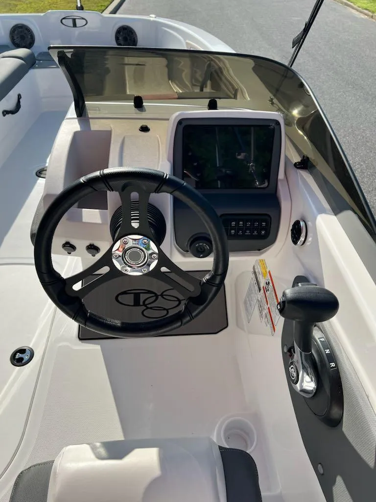 Slide: The Image of 2025 Tahoe T21 boat cockpit with steering wheel and control panel. - 11