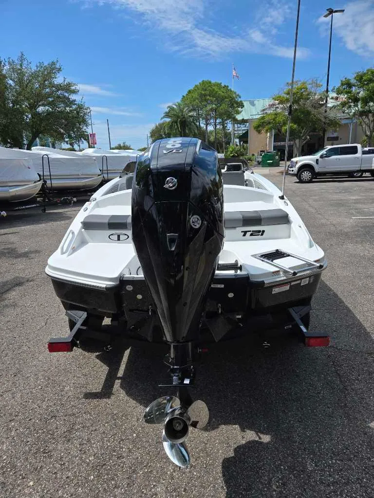 Slide: The Image of 2025 Tahoe T21 boat with outboard motor in a parking lot. - 2