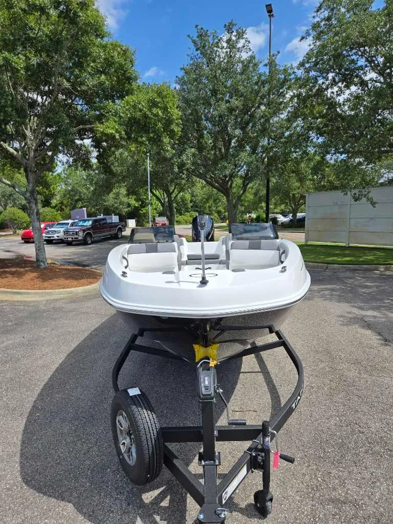 Slide: The Image of 2025 Tahoe T21 boat on trailer in sunny outdoor setting. - 3