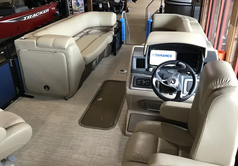 Slide: The Image of 2025 Regency 230 DL3 boat interior with plush seating and modern dashboard. - 3