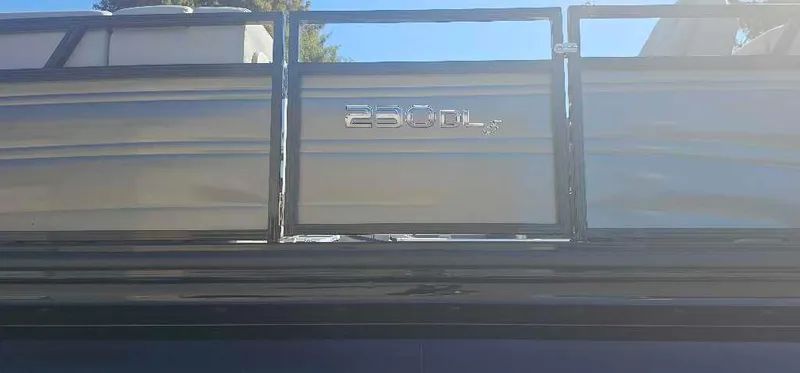 Slide: The Image of 2025 Regency 230 DL3 pontoon boat side view with logo. - 2