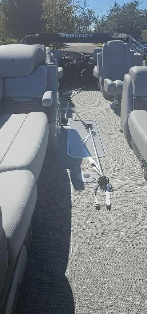 Slide: The Image of 2025 Regency 230 DL3 pontoon boat interior with plush seating and modern design. - 3
