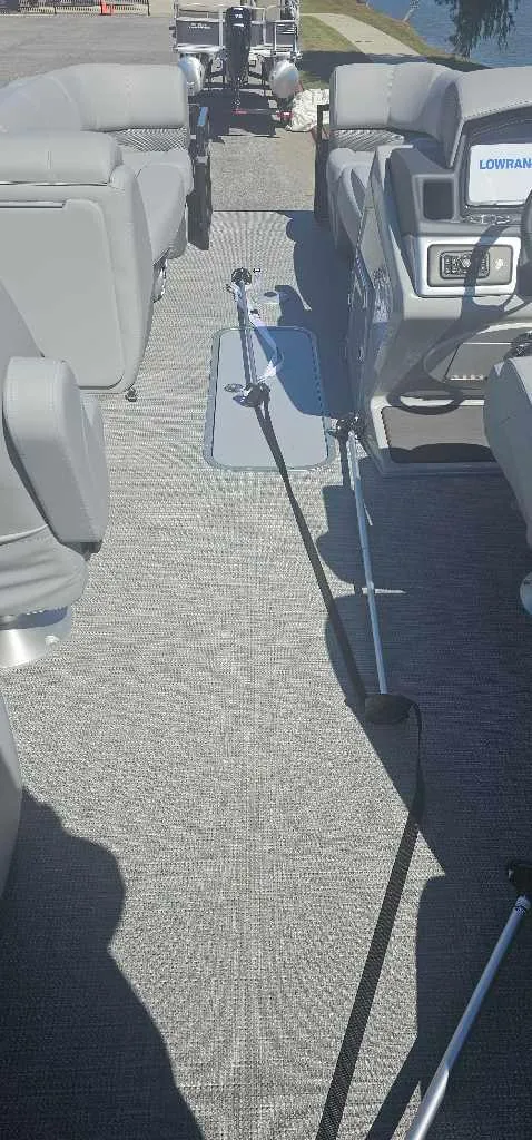 Slide: The Image of 2025 Regency 230 DL3 boat interior with gray seating and fishing rods. - 4