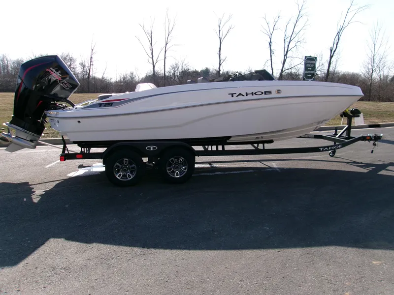 The Image of 2025 Tahoe T21 boat on trailer, parked outdoors, side view. - 0