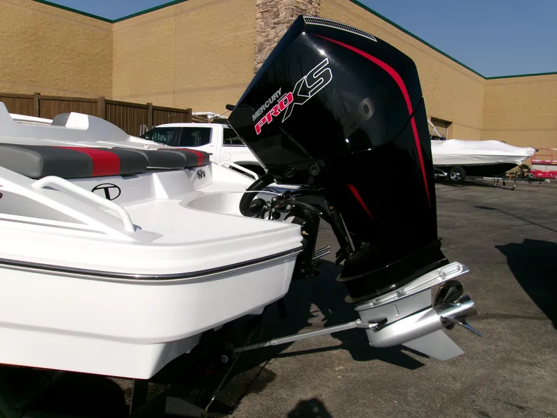 Slide: The Image of 2025 Tahoe T21 boat with powerful outboard motor in a parking lot. - 4