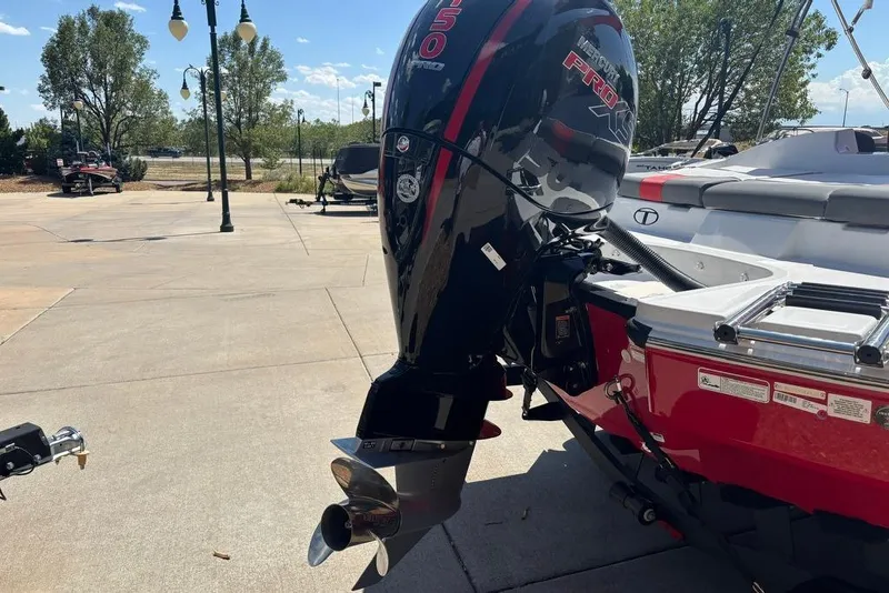 Slide: The Image of ```json { "alt_text": "2025 Tahoe T21 boat with powerful outboard motor in a sunny outdoor setting." } ``` - 13