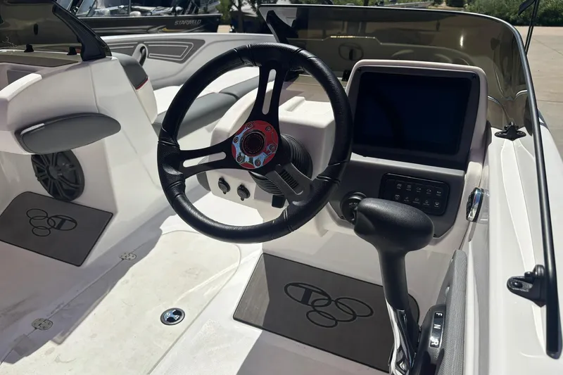 Slide: The Image of Interior of 2025 Tahoe T21 boat featuring steering wheel and control panel. - 9