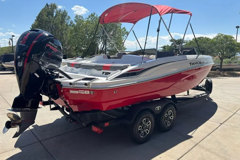 Slide: The Image of 2025 Tahoe T21 boat with red canopy and Mercury engine on trailer. - 3