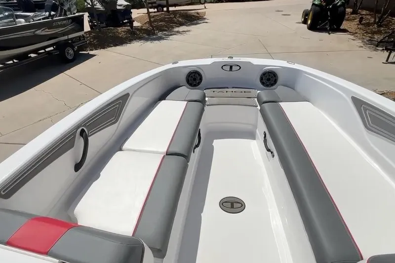 Slide: The Image of 2025 Tahoe T21 boat interior with gray and white seating, outdoor setting. - 11
