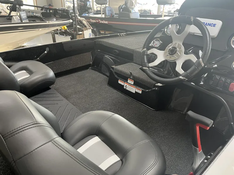 Slide: The Image of Interior of a 2025 Nitro Z17 boat featuring sleek black seating and modern steering console. - 3