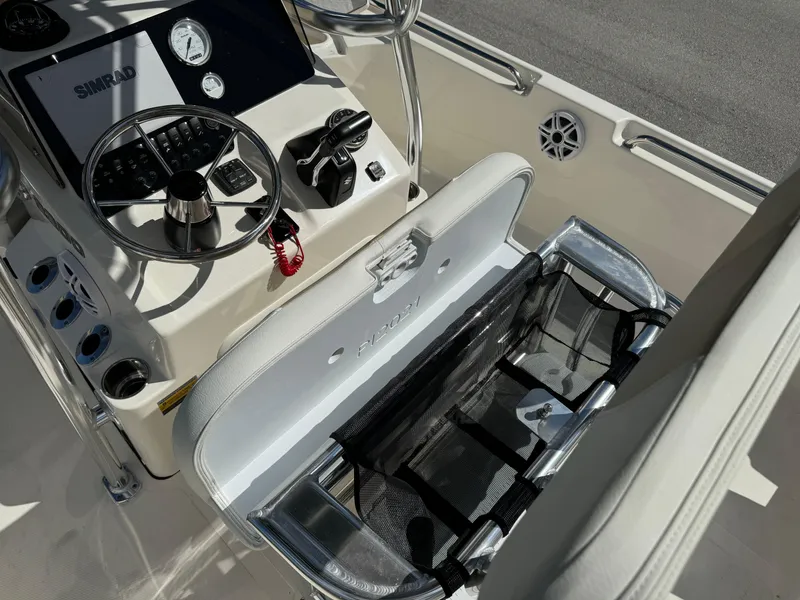 Slide: The Image of 2025 Bulls Bay 2200 boat console with steering wheel and storage compartment. - 14