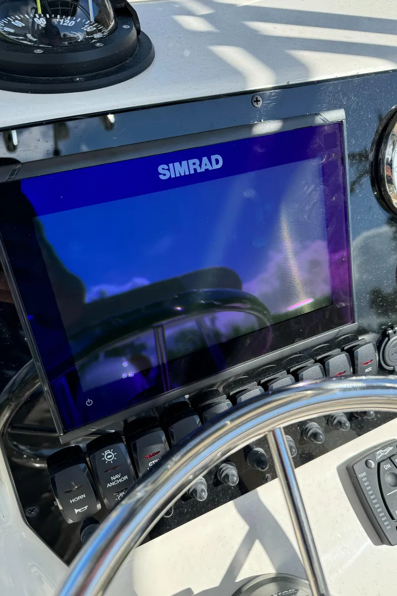 Slide: The Image of Simrad display on 2025 Bulls Bay 2200 boat dashboard with steering wheel. - 15