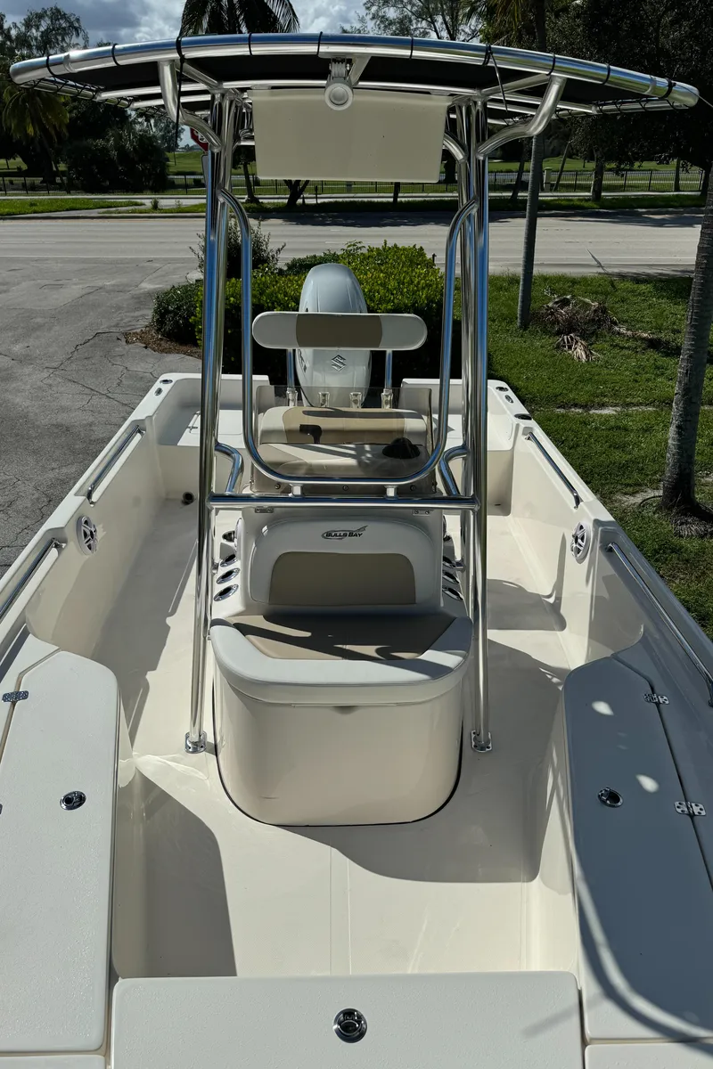 Slide: The Image of 2025 Bulls Bay 2200 boat with center console and seating, parked outdoors. - 17