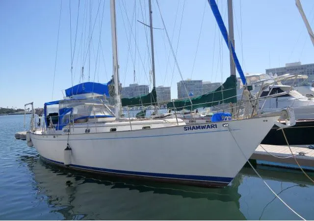 Slide: The Image of 1976 Peterson 44 sailboat "Shamwari" docked in a marina. - 1