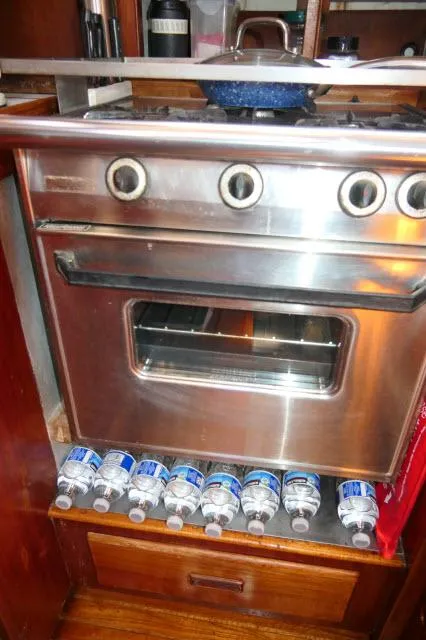 Slide: The Image of Vintage 1976 Peterson model 44 oven with water bottles stored below. - 13