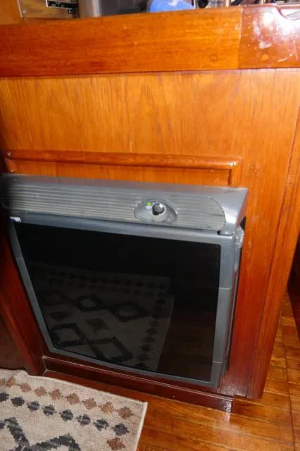 Slide: The Image of Vintage Peterson 44 wood-paneled appliance, 1976 model, with a black front panel. - 15